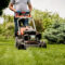 Buttrose Gardener mowing the lawn. Landscape design. Gardening