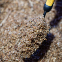 Saw dust ground cover with shovel